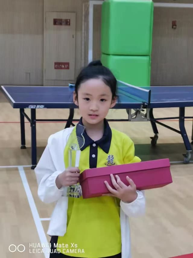 Alice playing table tennis at a young age